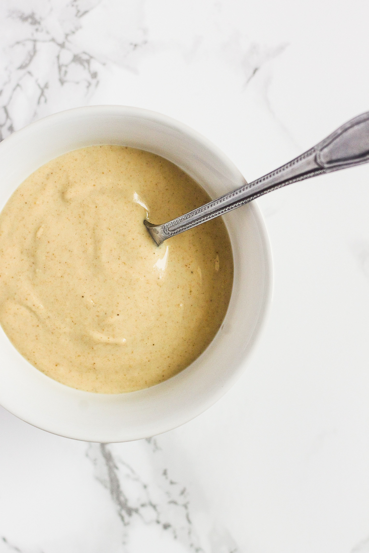 lemon tahini sauce in white bowl