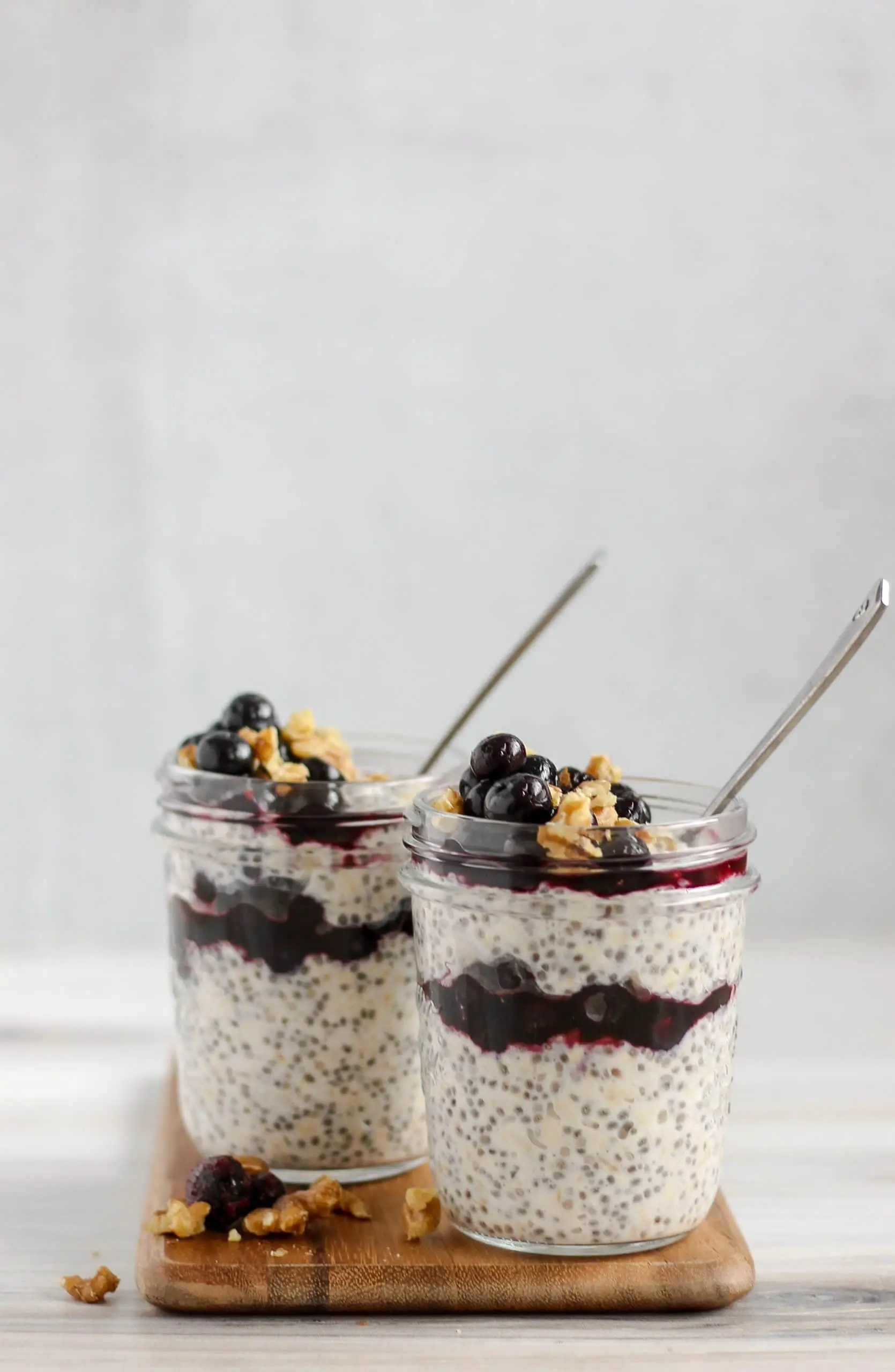 two mason jars filled with blueberry chia overnight oats