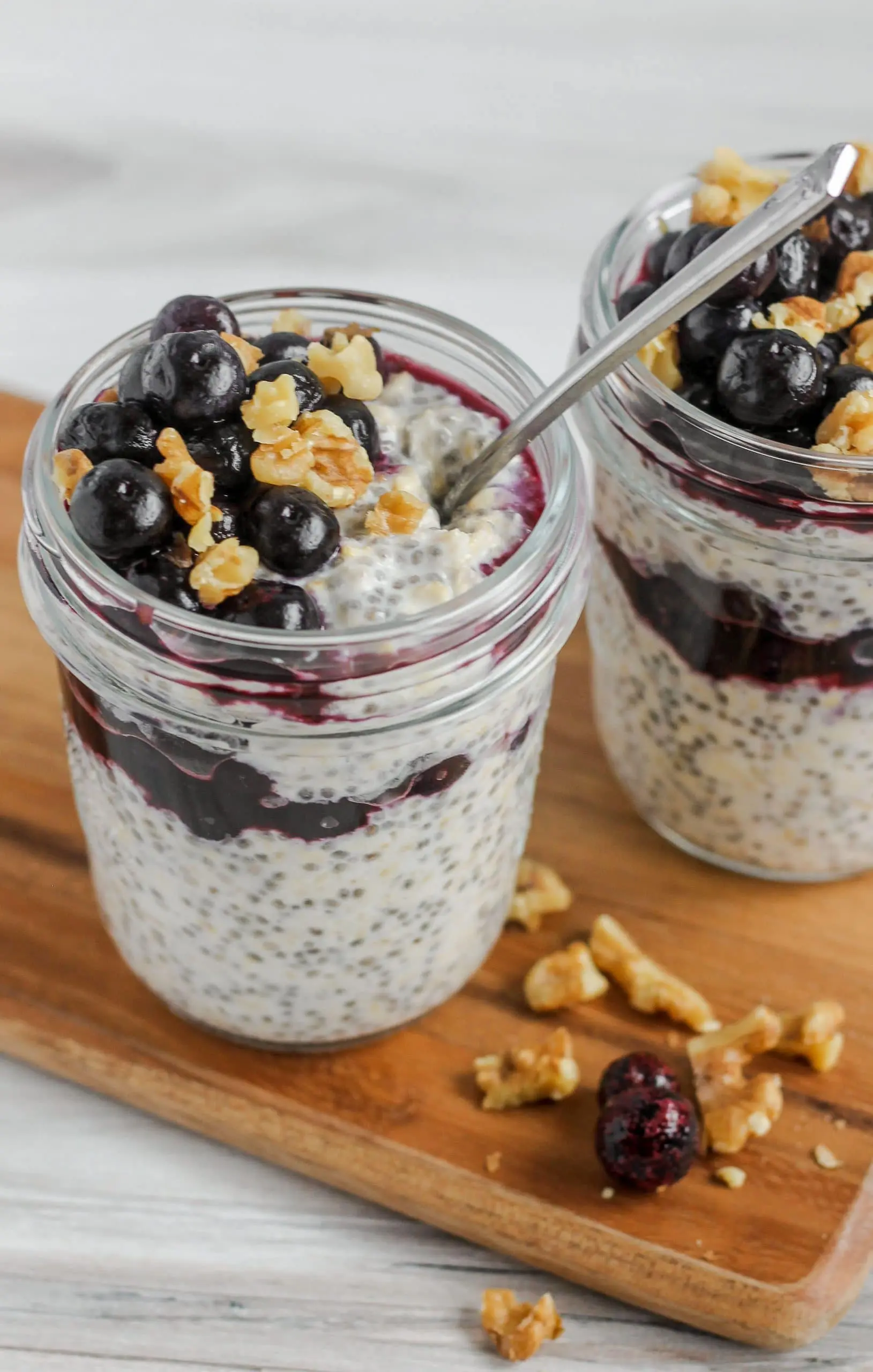 overnight oats in mason jar topped with blueberries and walnuts