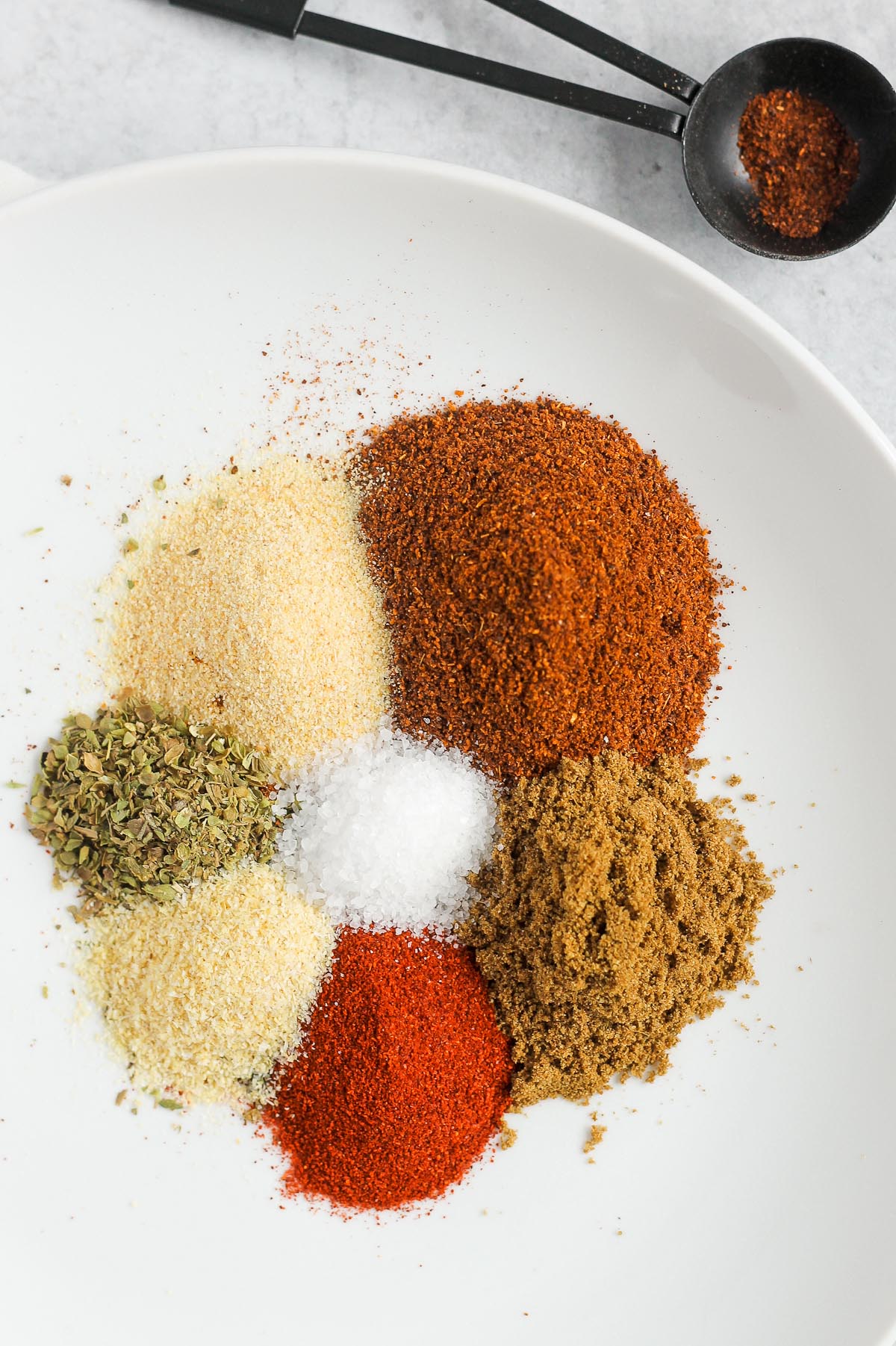 taco seasoning ingredients piled on a white plate