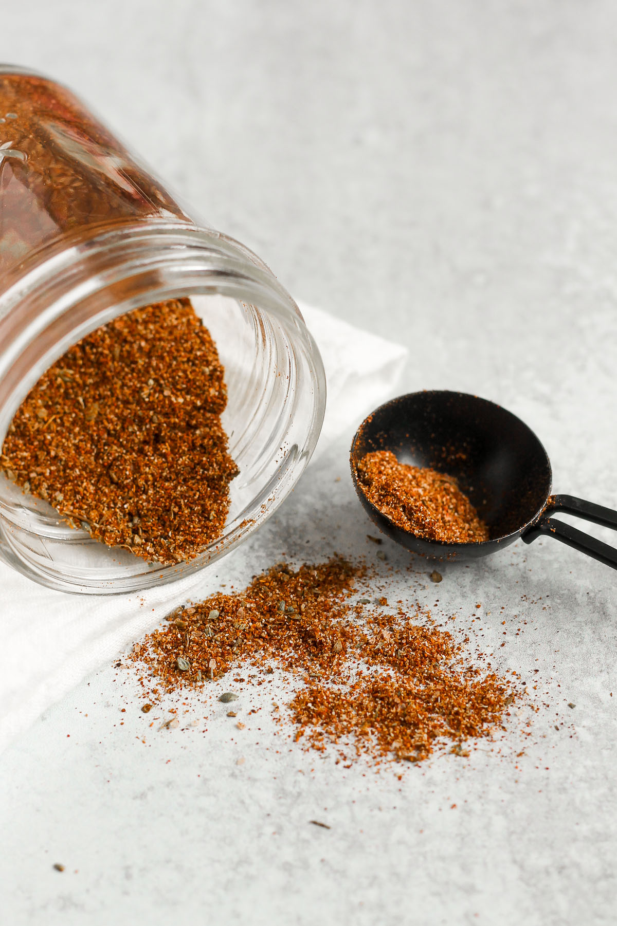 taco seasoning being poured from a mason jar