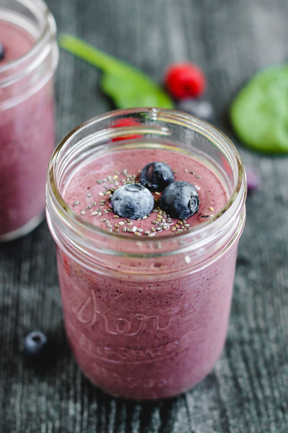 side angle view of the berry spinach smoothie in a glass mason jar