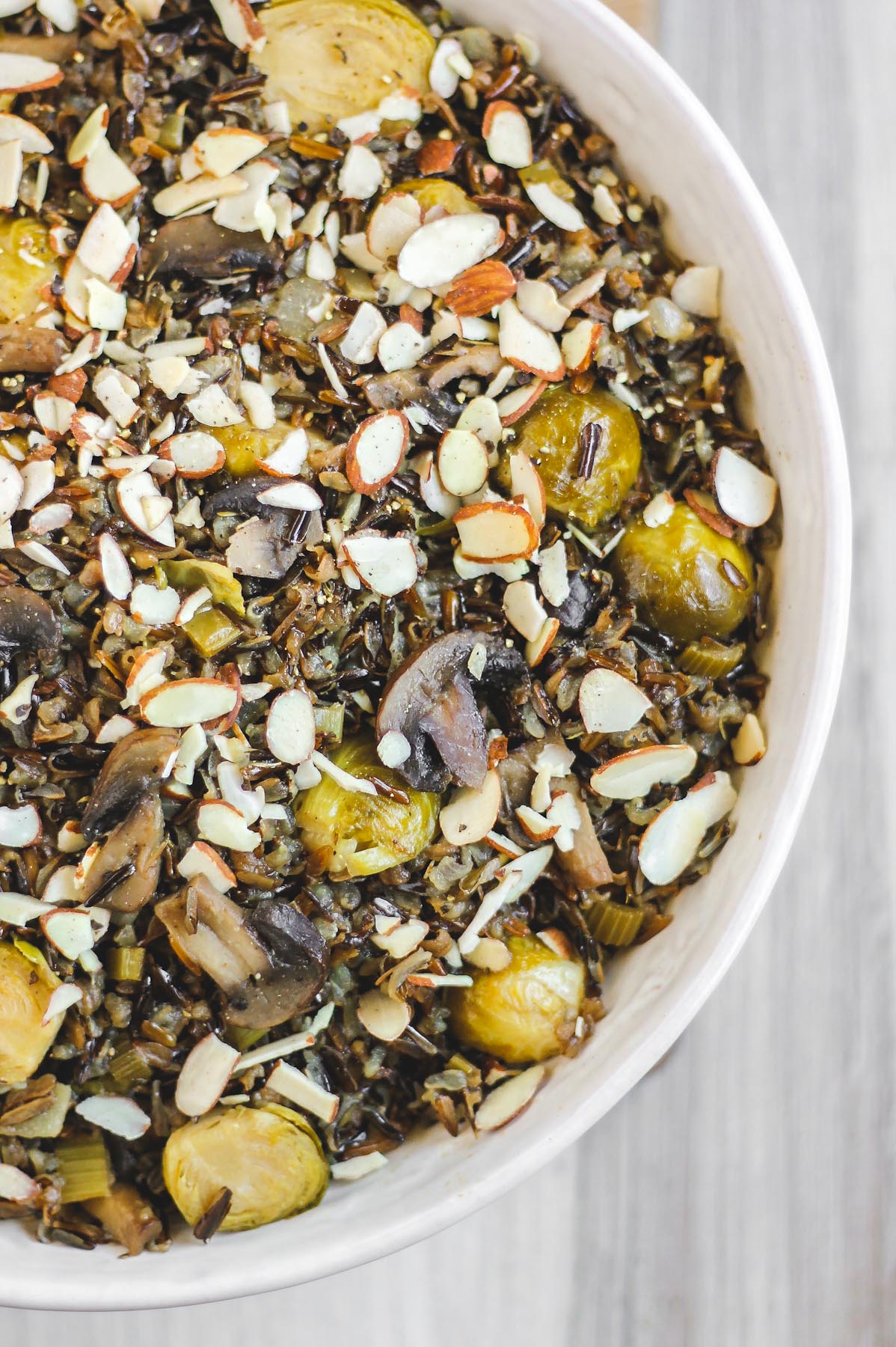close up view of cooked wild rice pilaf in large white serving bowl