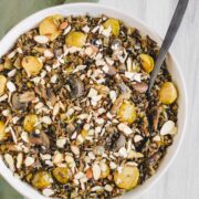 overhead view of finished pilaf in large serving bowl sprinkled with sliced almonds