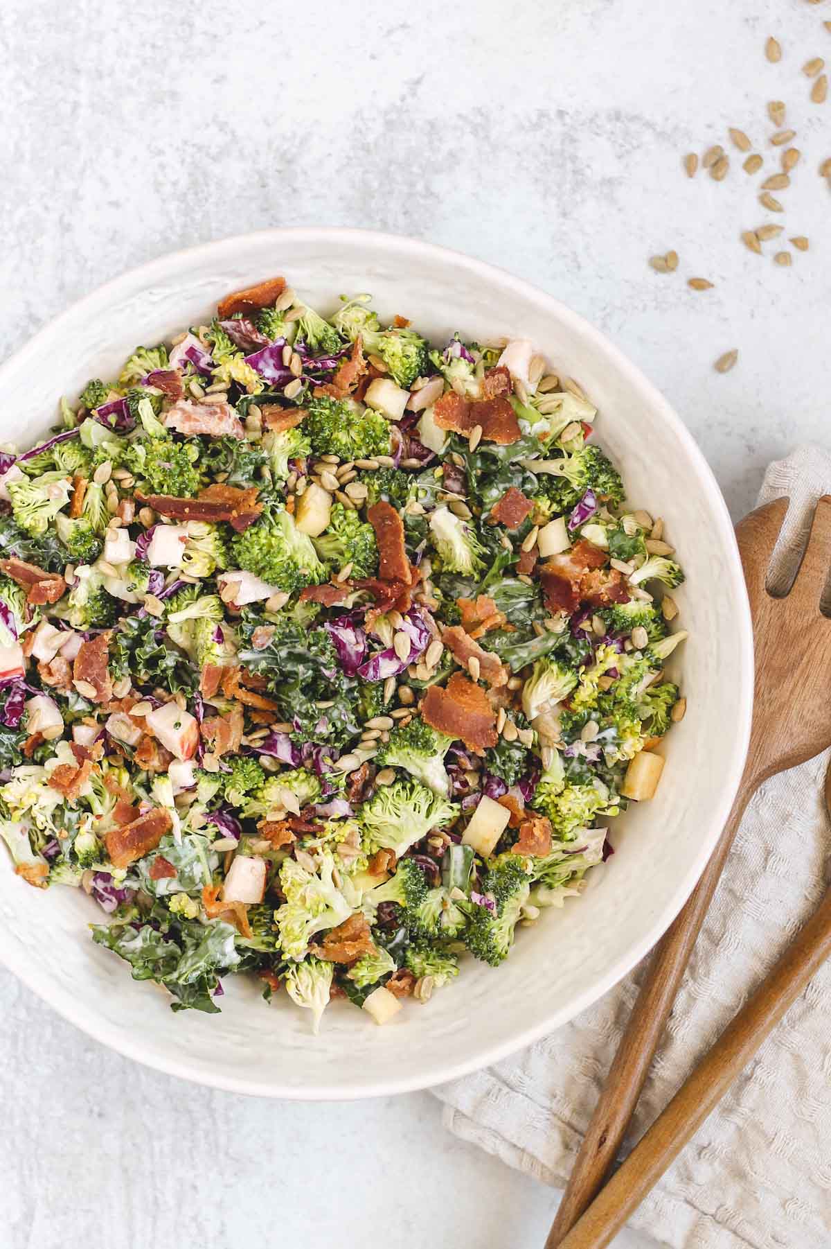 healthy broccoli salad in large white serving bowl