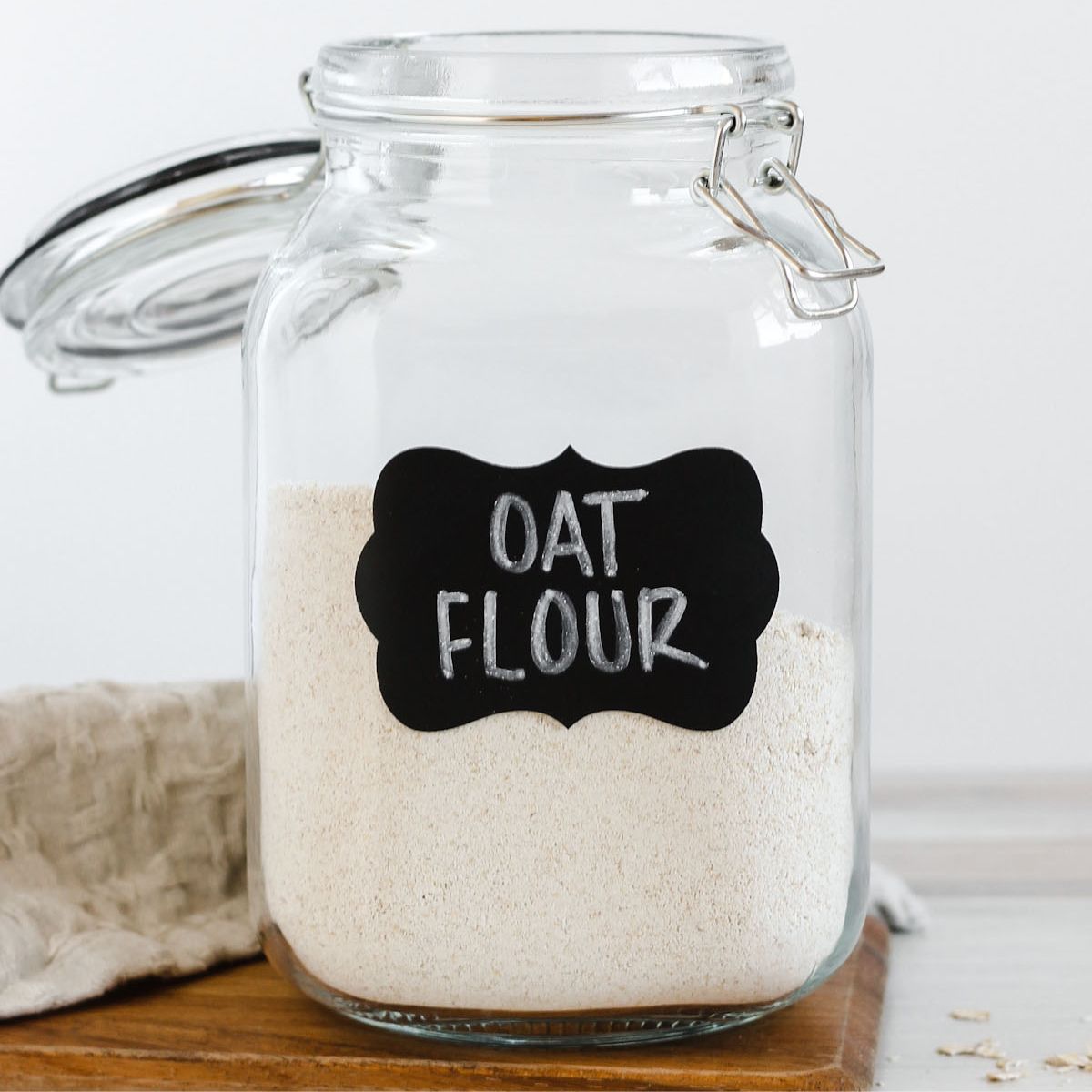 Oat flour in a labeled glass canister.