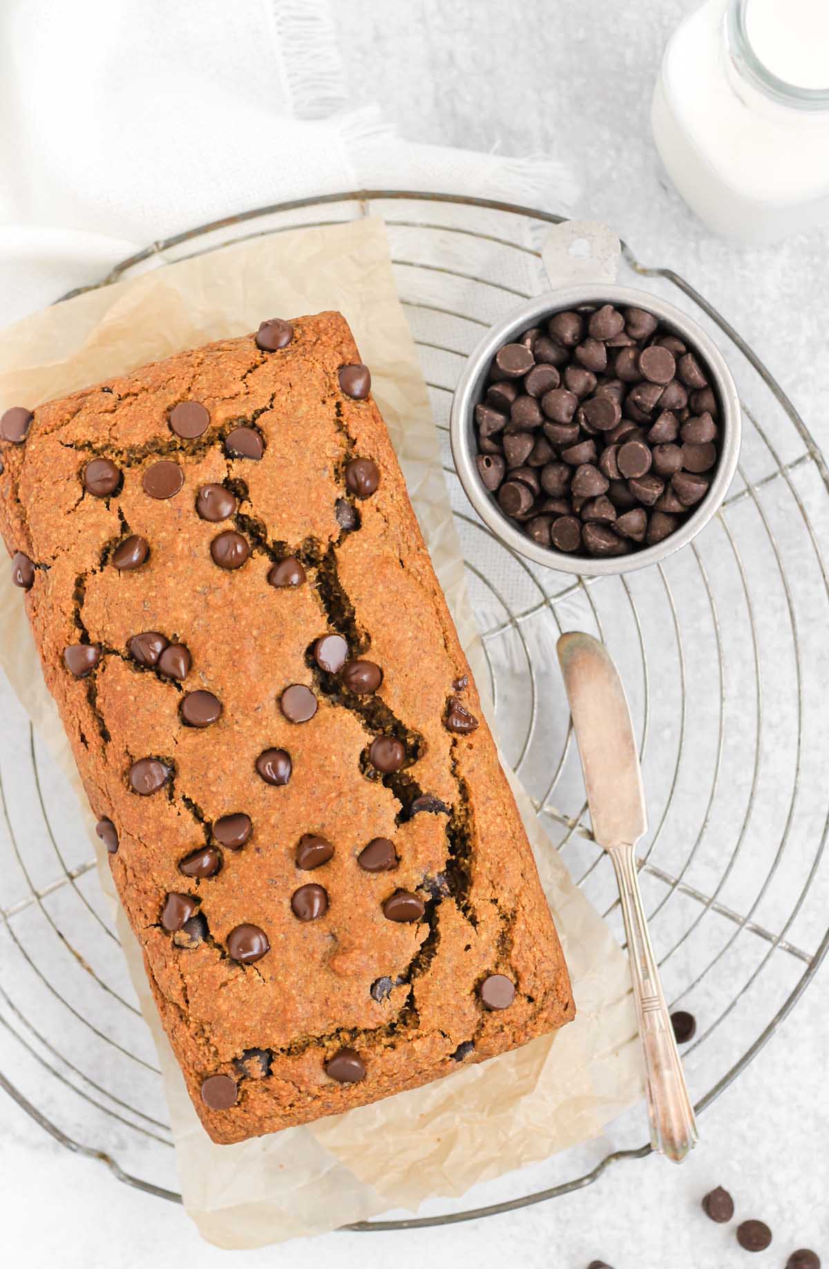 Gluten-free pumpkin chocolate chip loaf on a round wire cooling rack.