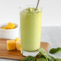 Creamy green smoothie in a tall glass.