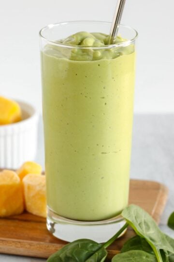 Creamy green smoothie in a tall glass.