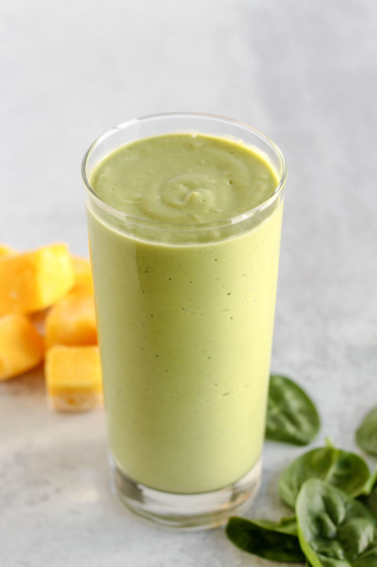 Creamy green smoothie in a tall glass.