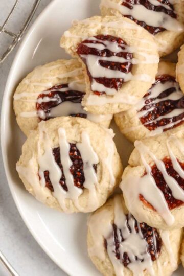 Gluten-free raspberry thumbprint cookies on a plate.