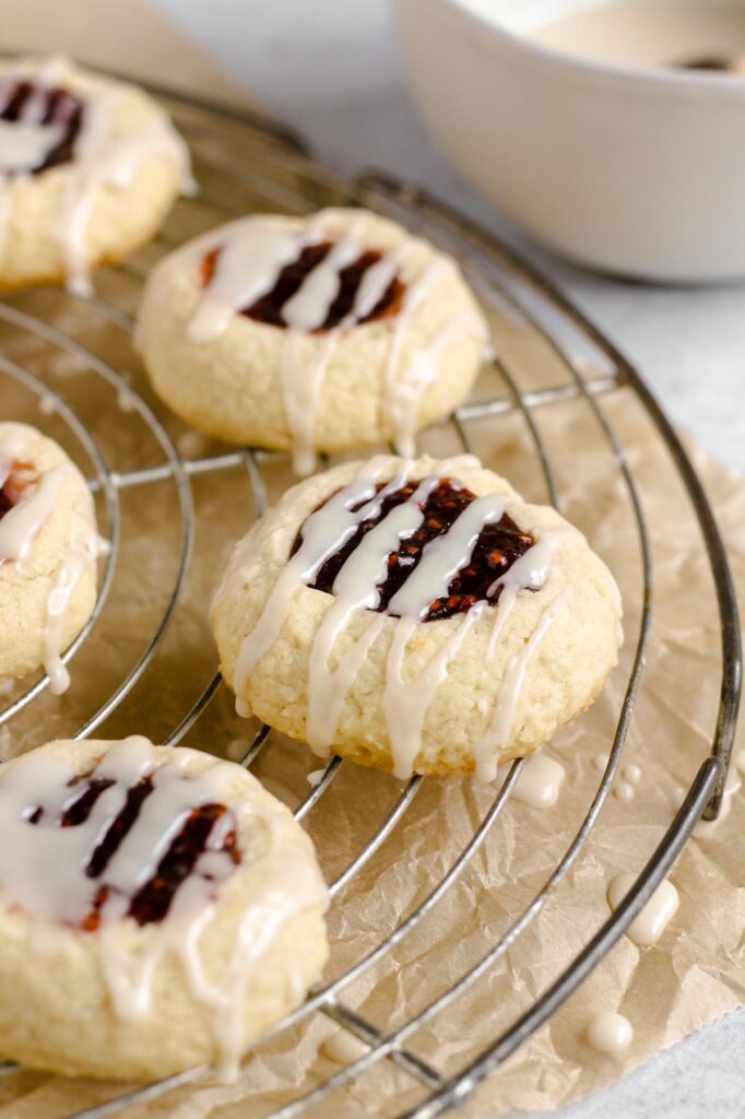 Close up of thumbprint cookies with drizzled glaze.
