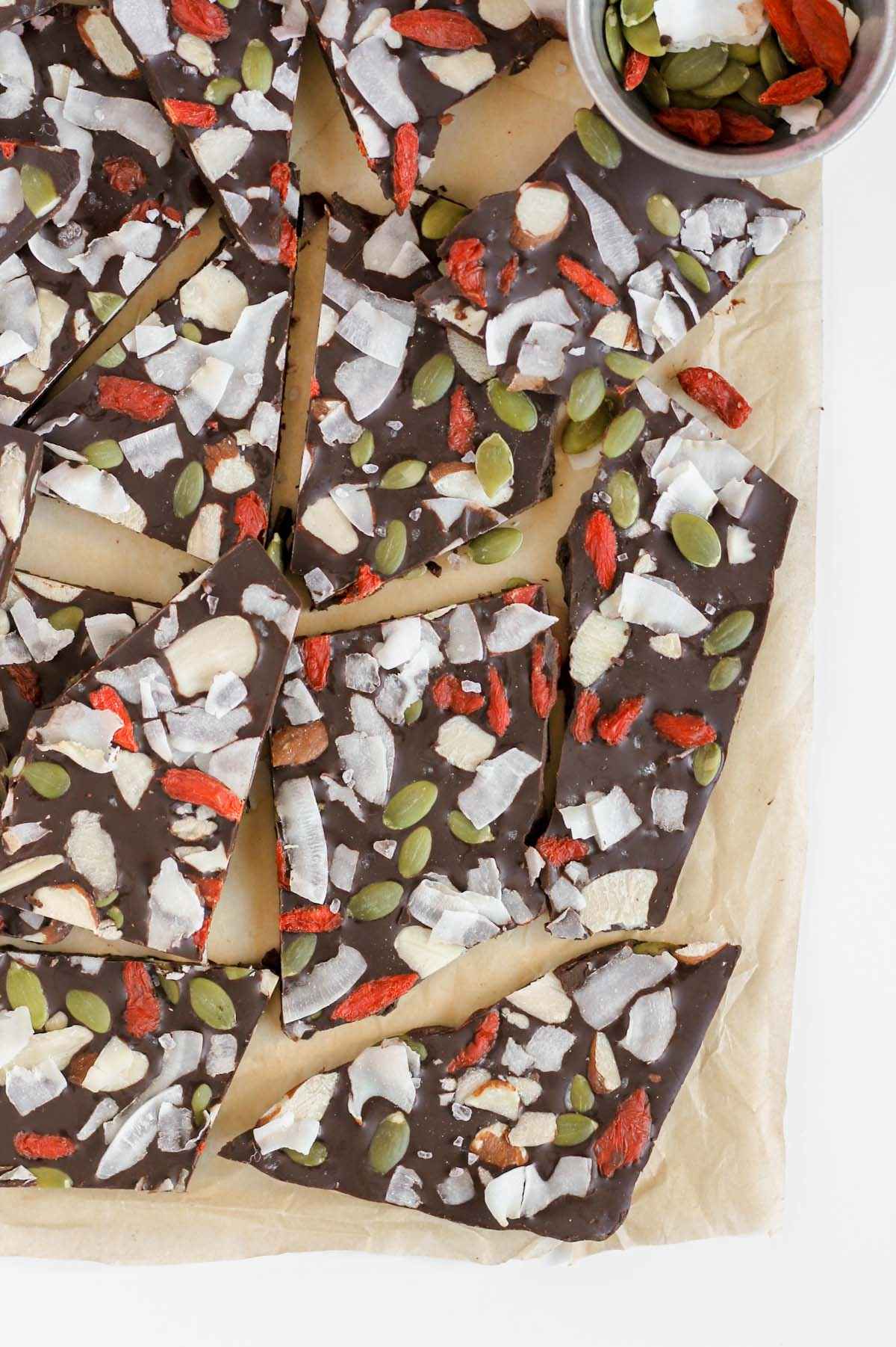 Pieces of chocolate bark with dried fruit, nuts, and seeds.