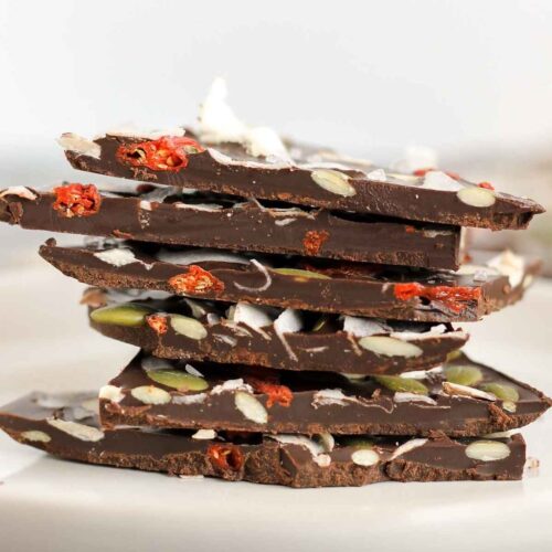 Pieces of dark chocolate bark stacked on top of one another.
