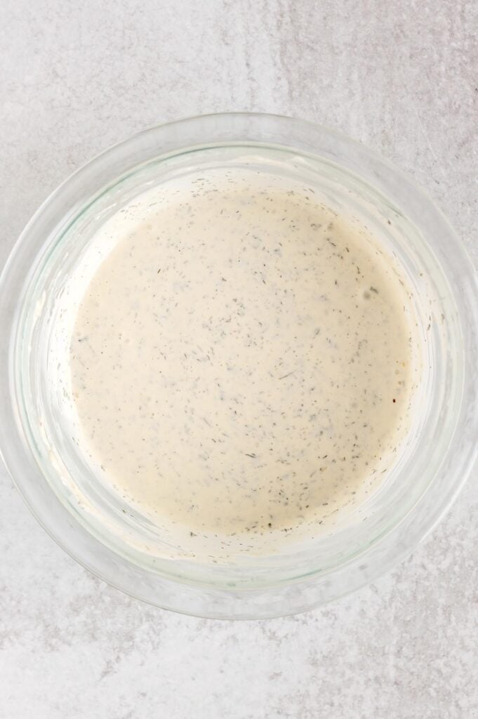 Dairy-free ranch dressing in a glass mixing bowl.