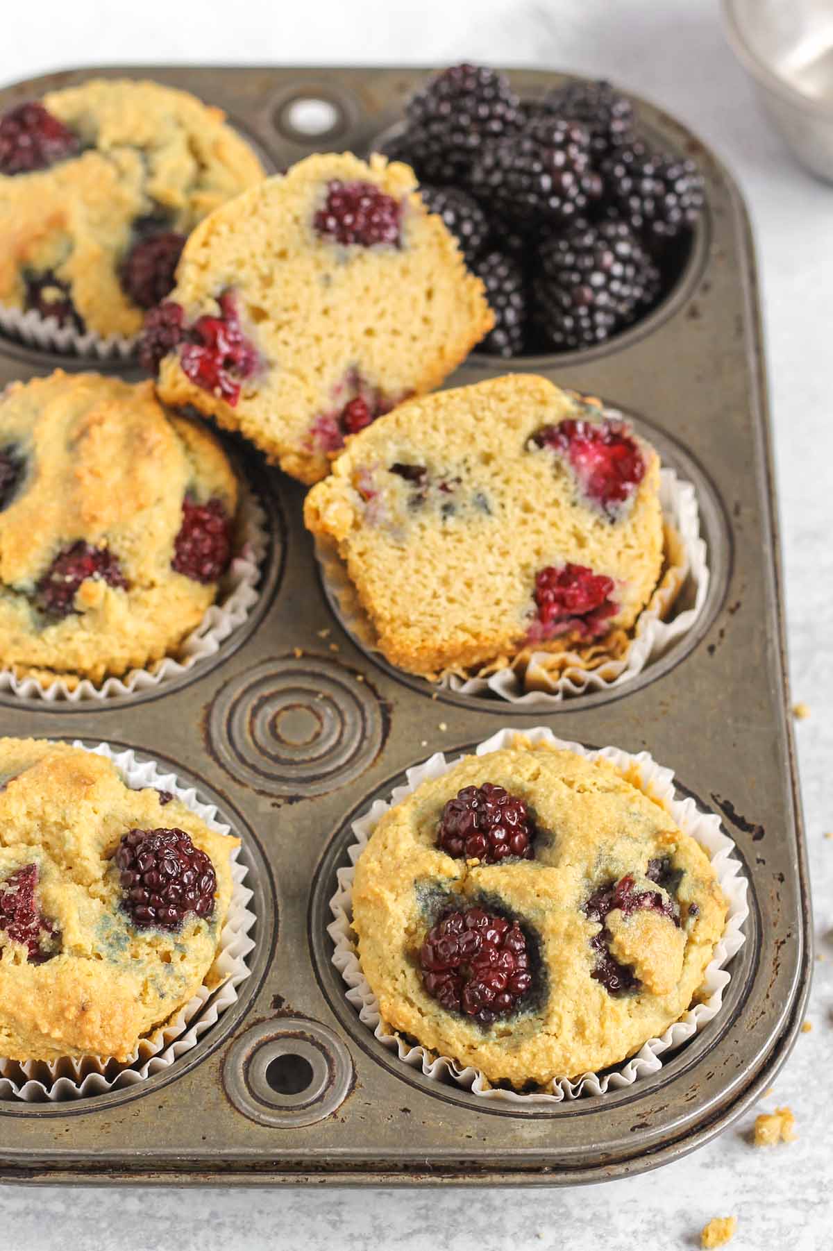 Blackberry almond flour muffins in a vintage muffin tin.