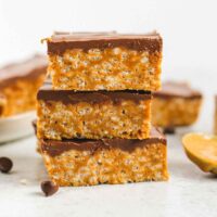 Healthier scotcheroo bars stacked 3 high.