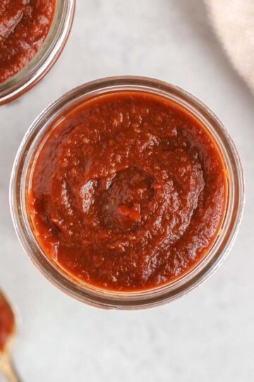 Overhead view of BBQ sauce in a mason jar.
