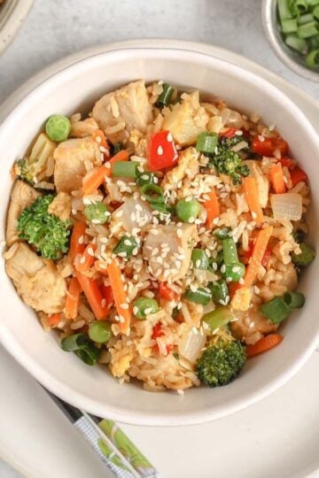Chicken fried rice with lots of veggies in a single serve dish.
