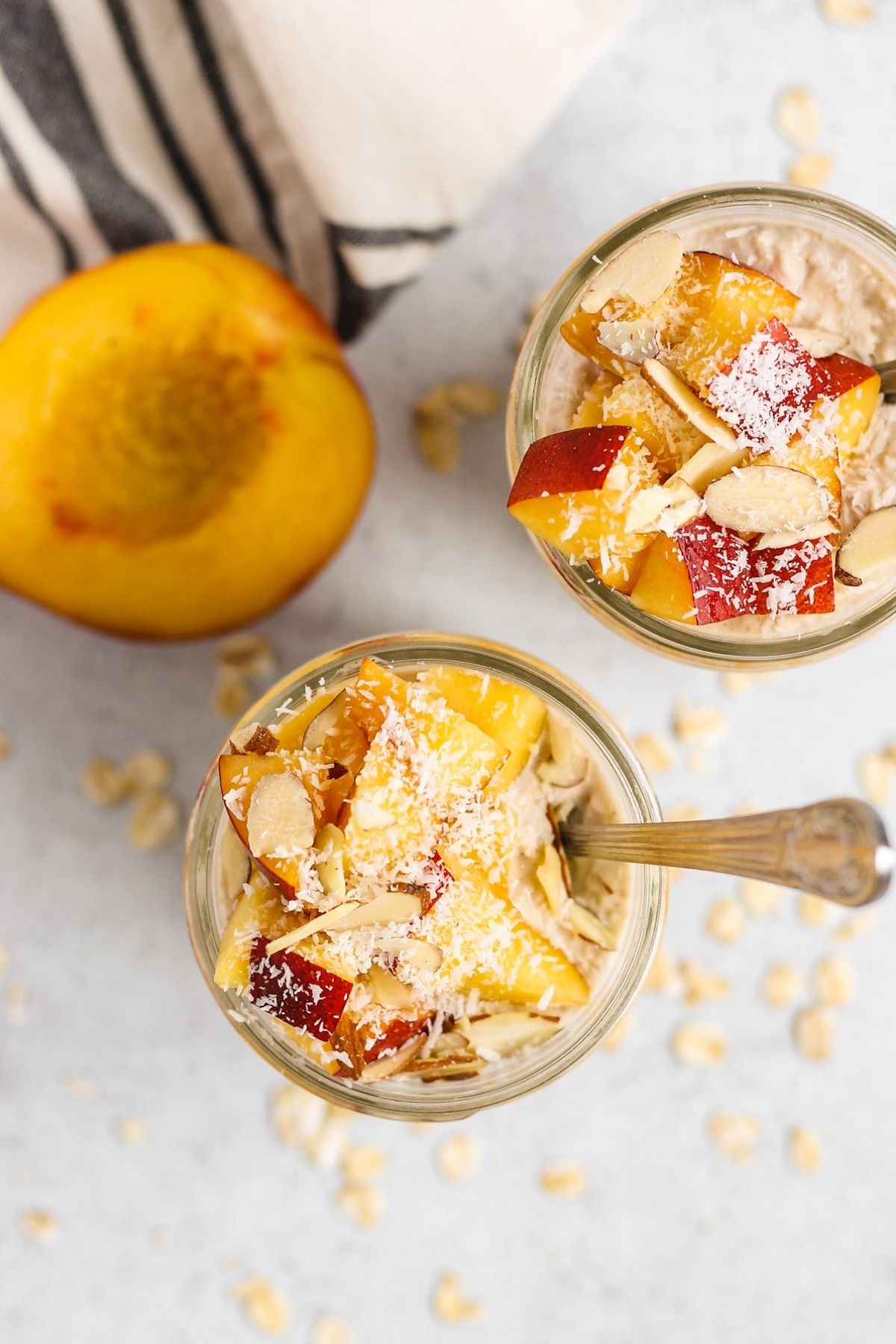 Overhead view of overnight oats in a mason jar topped with peaches.