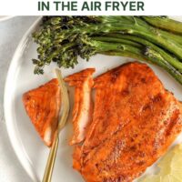 Fork cutting into salmon with text overlay "delicious frozen salmon in the air fryer."