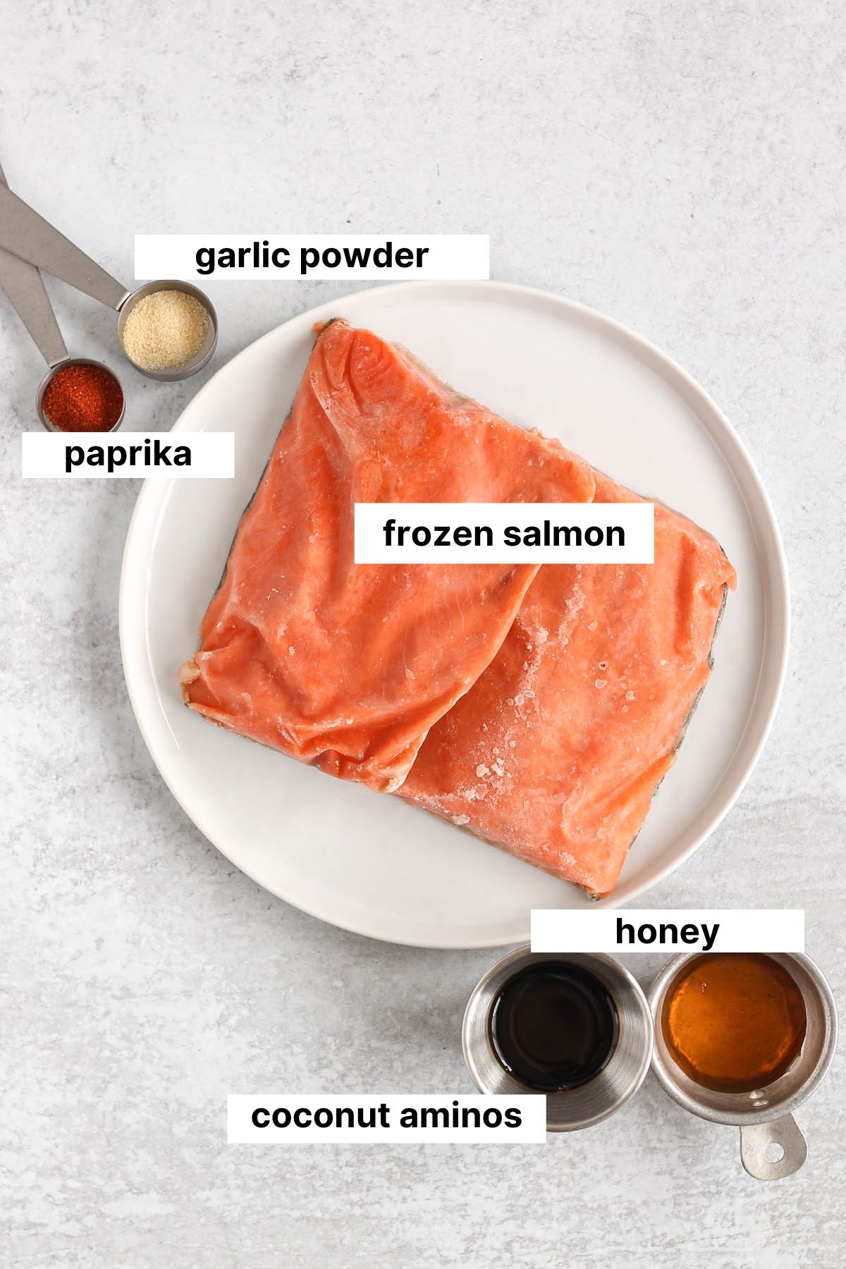 Labeled ingredients needed for frozen salmon in the air fryer.