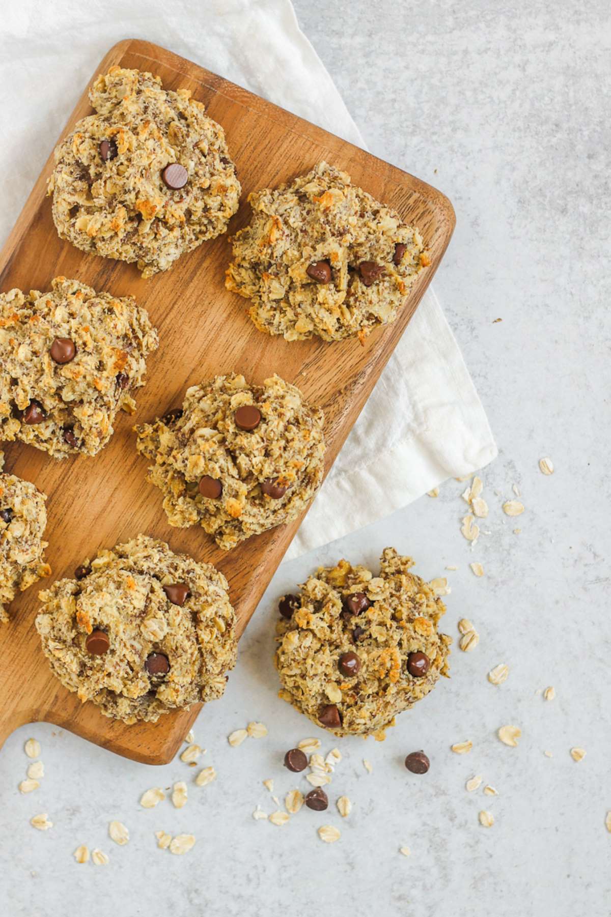 Breakfast oatmeal cookies on a wood cutting board.