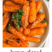 Air fried baby carrots on a plate with text overlay "honey glazed air fryer baby carrots."