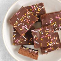 Chocolate protein with sprinkles laid out on a white plate.