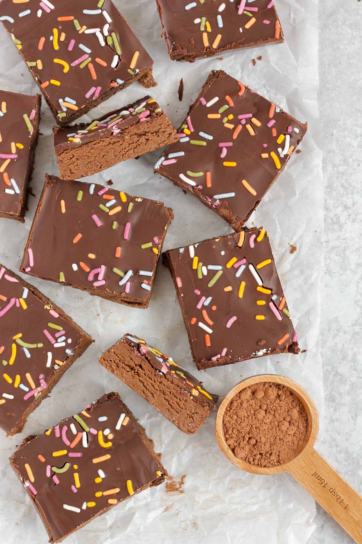 Cut up chocolate protein bars on crinkled white parchment paper.