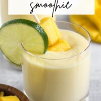 Short glass filled with a creamy yellow smoothie with text overlay "mango pineapple smoothie."