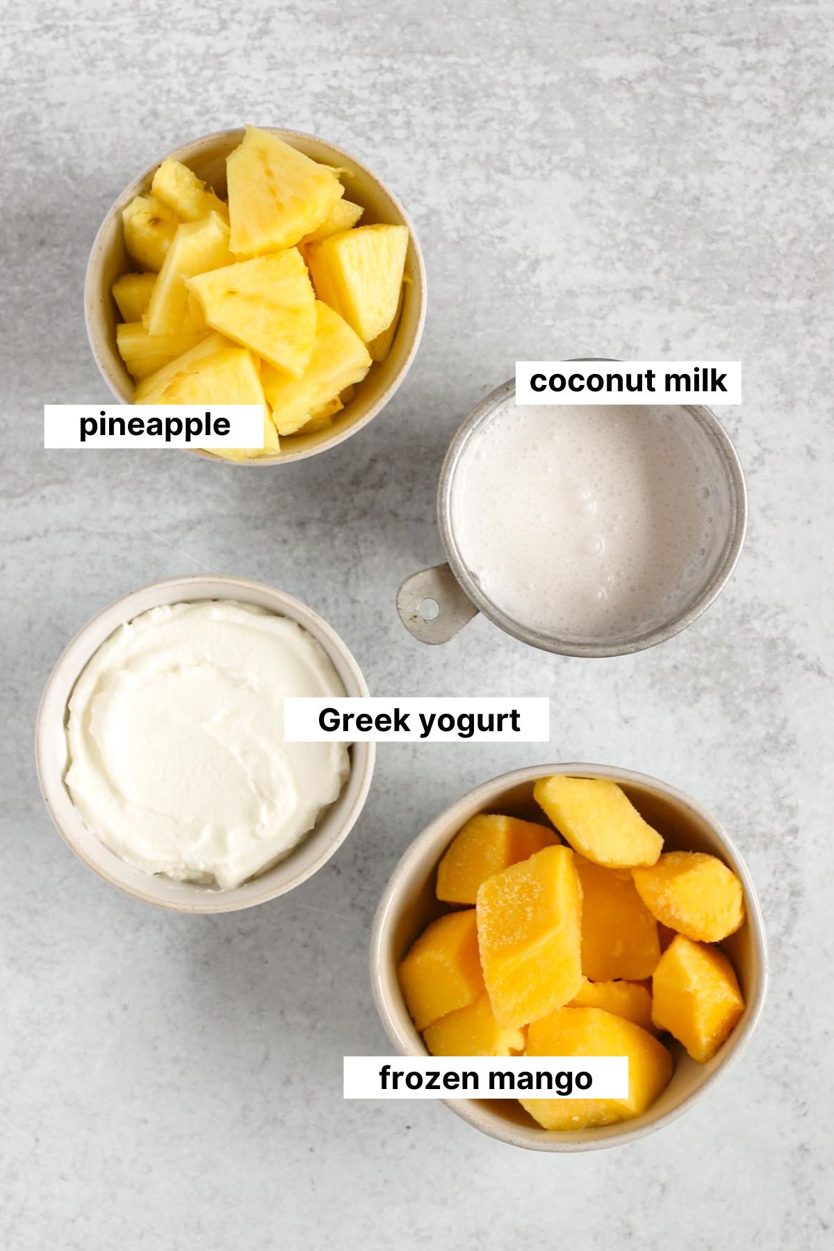 Labeled ingredients needed for mango pineapple smoothie.