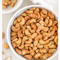 Roasted cashews in a bowl with text overlay "how to roast cashews."