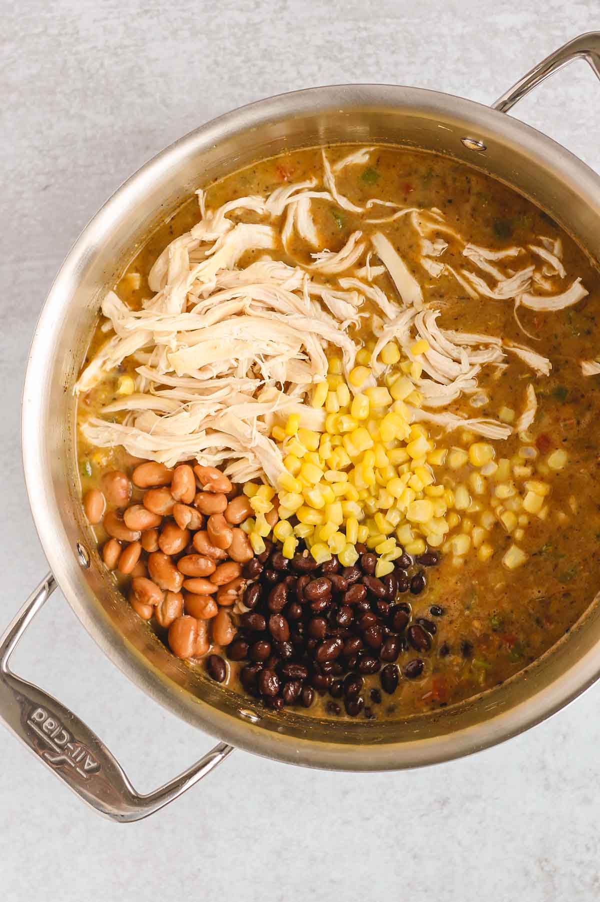 Base of chicken chili with shredded chicken, corn, and beans added in.