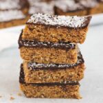 Peanut butter oat bar squares stacked 4 high.