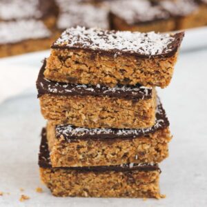 Peanut butter oat bar squares stacked 4 high.
