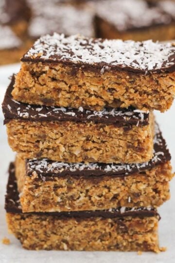 Peanut butter oat bar squares stacked 4 high.