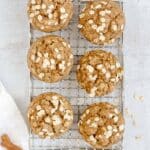 Apple cinnamon oat muffins on a wire cooling rack.