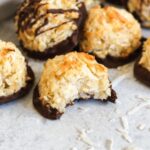 Coconut macaroon cookie with a bite taken out of it.