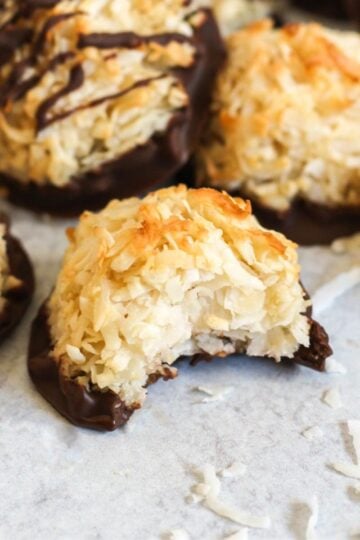 Coconut macaroon cookie with a bite taken out of it.