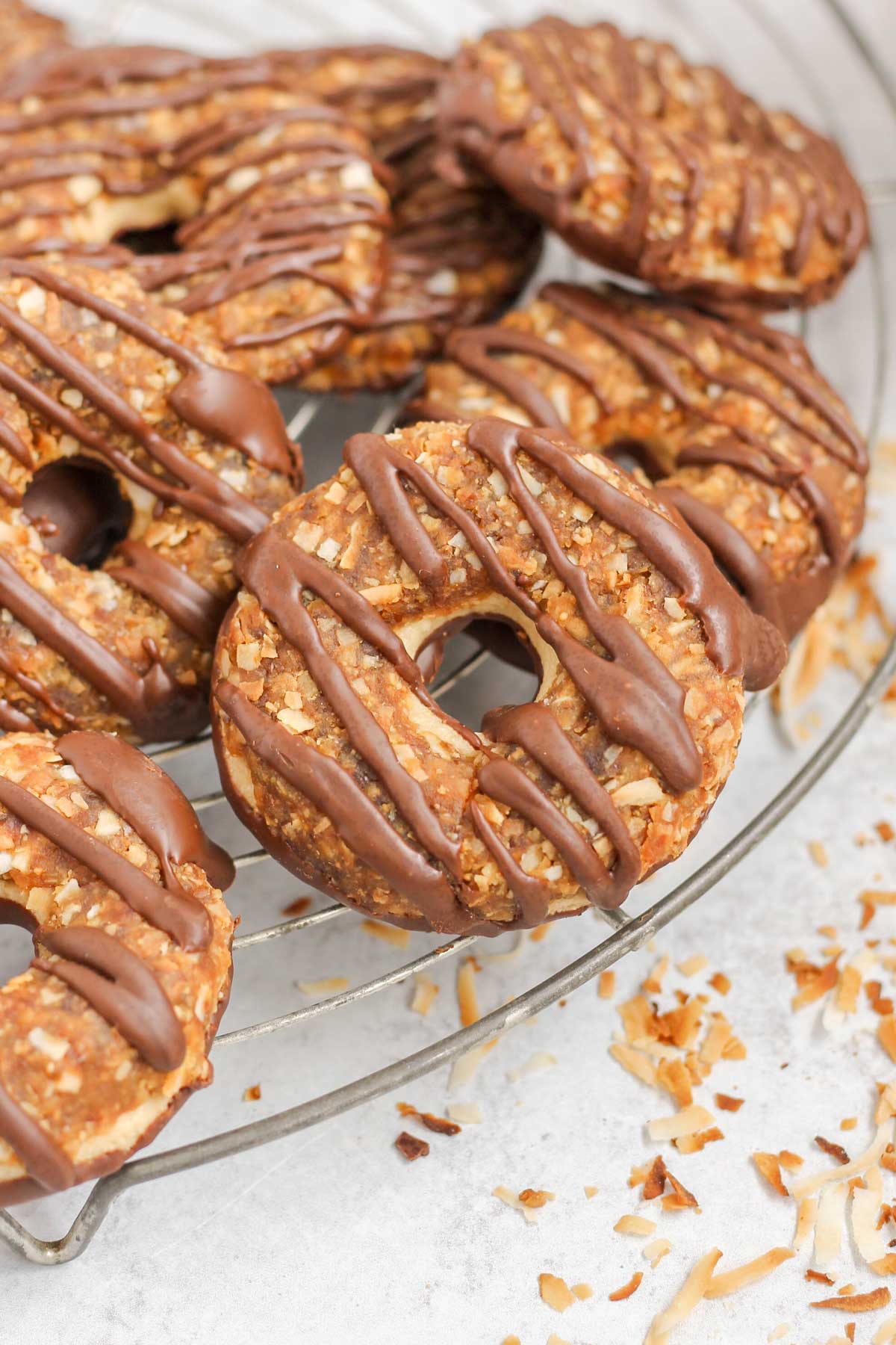 Homemade Samoa cookies on a round wire cooling rack.