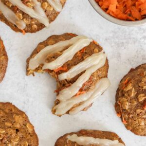 Carrot cake oatmeal cookie with coconut butter frosting in a zig zag pattern on the top.
