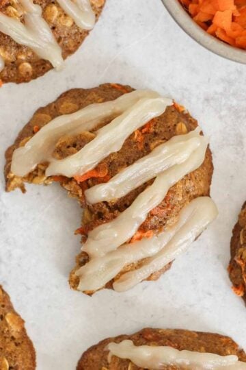 Carrot cake oatmeal cookie with coconut butter frosting in a zig zag pattern on the top.