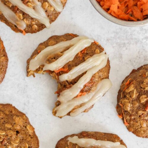 Carrot cake oatmeal cookie with coconut butter frosting in a zig zag pattern on the top.