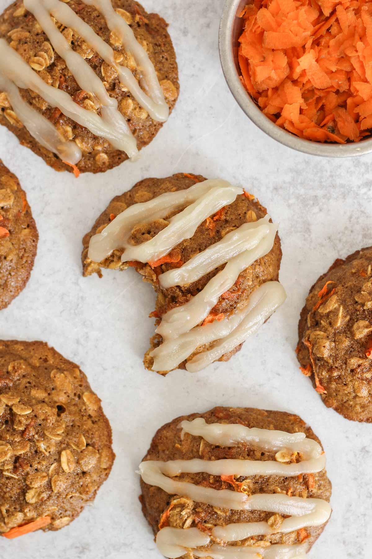 Carrot cake oatmeal cookie with coconut butter frosting in a zig zag pattern on the top.