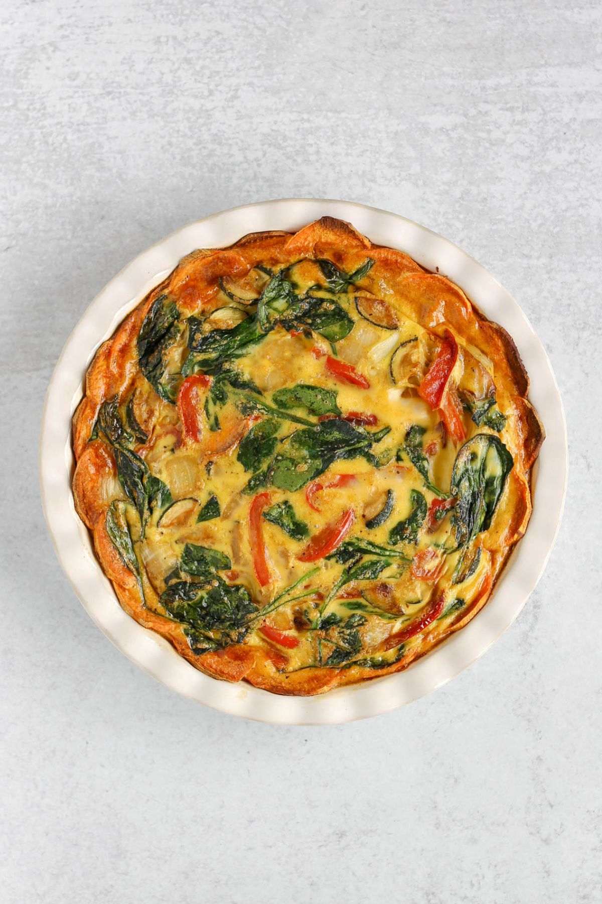 Baked sweet potato crust quiche in a pie dish.