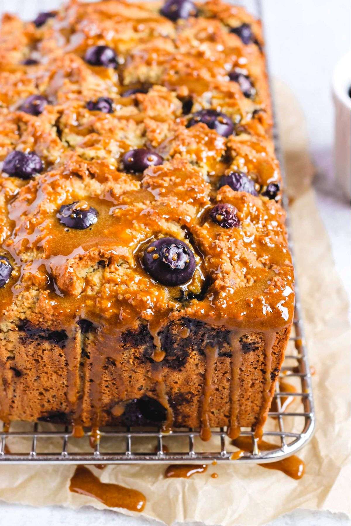 Almond flour blueberry bread loaf drizzled with coconut sugar glaze.