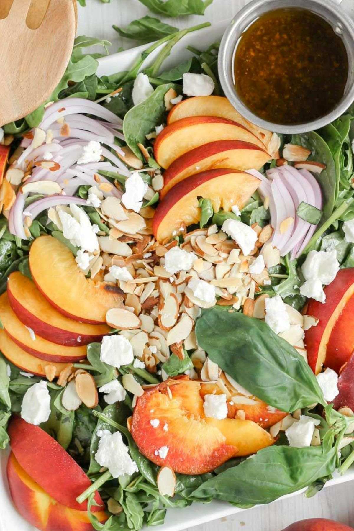 Mixed greens topped with sliced peaches, slivered almonds, red onion slices, goat cheese crumbles with a side of vinaigrette dressing.