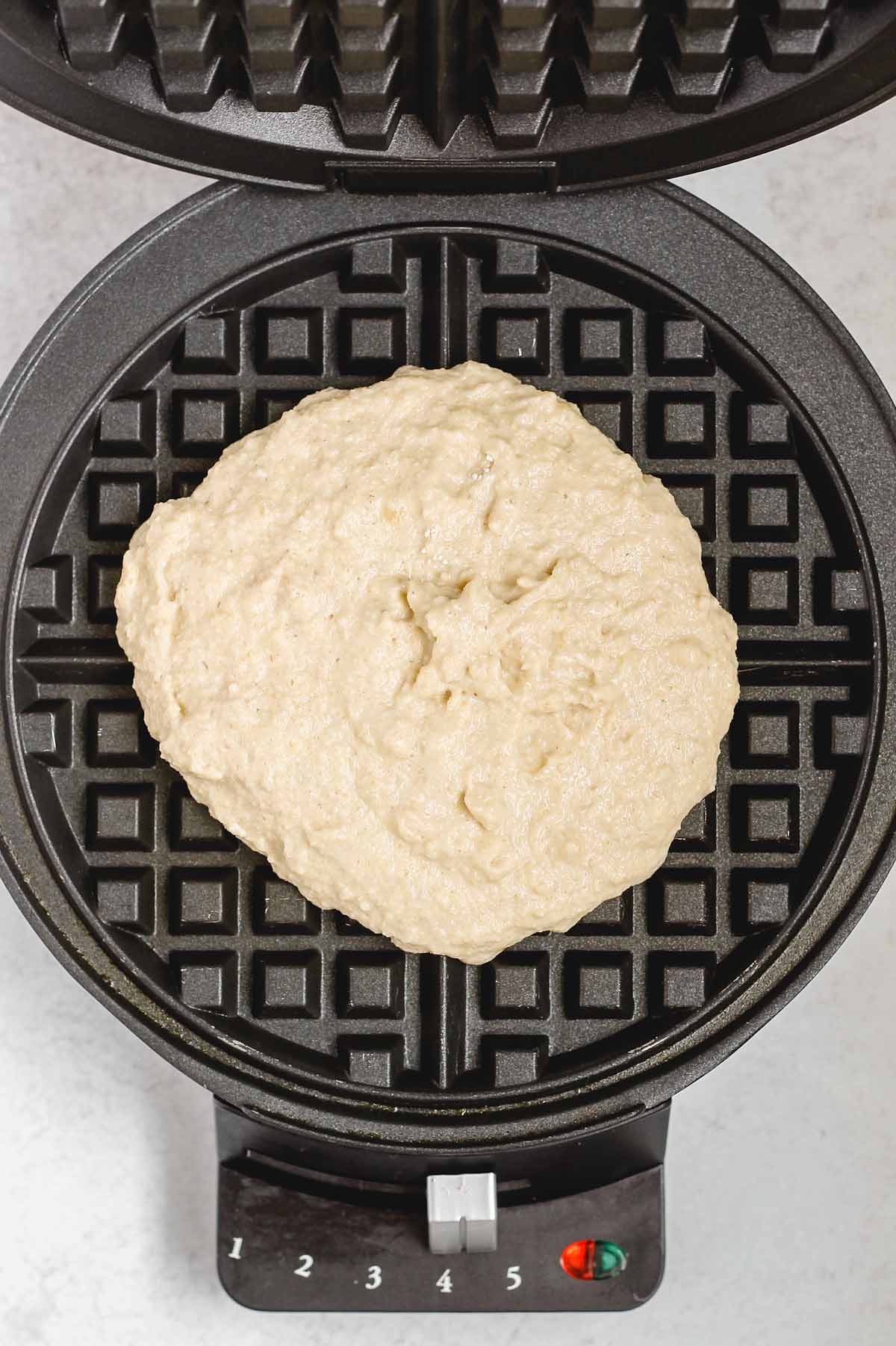 Waffle batter in a waffle iron before being cooked.