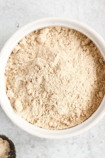 Coconut powdered sugar in a small white dish.